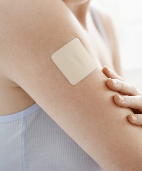 Woman with Patch on Arm